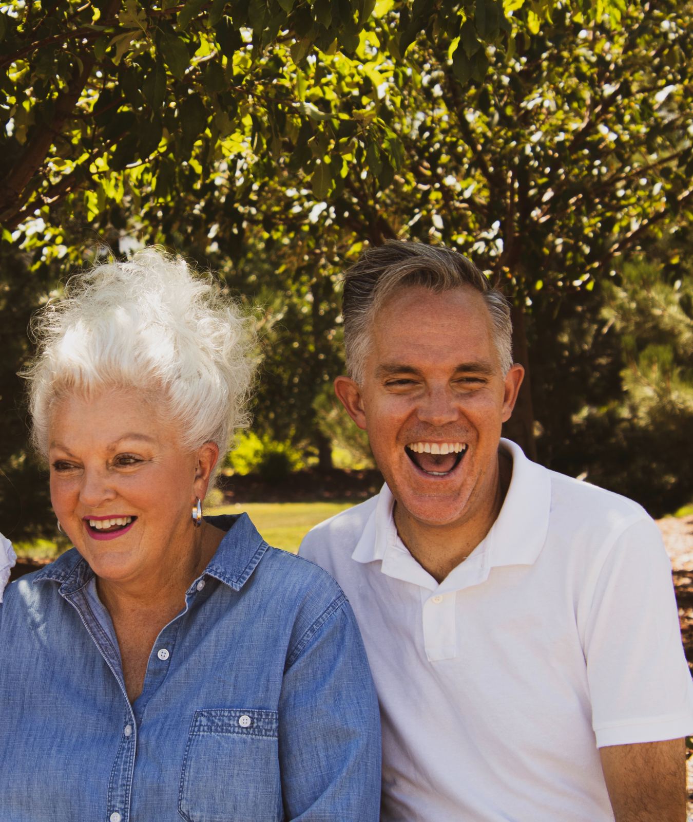 An older couple laughing together outdoors